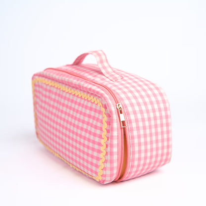 Brown gingham Dyson Airwrap travel pouch with pink detailing and organised compartments