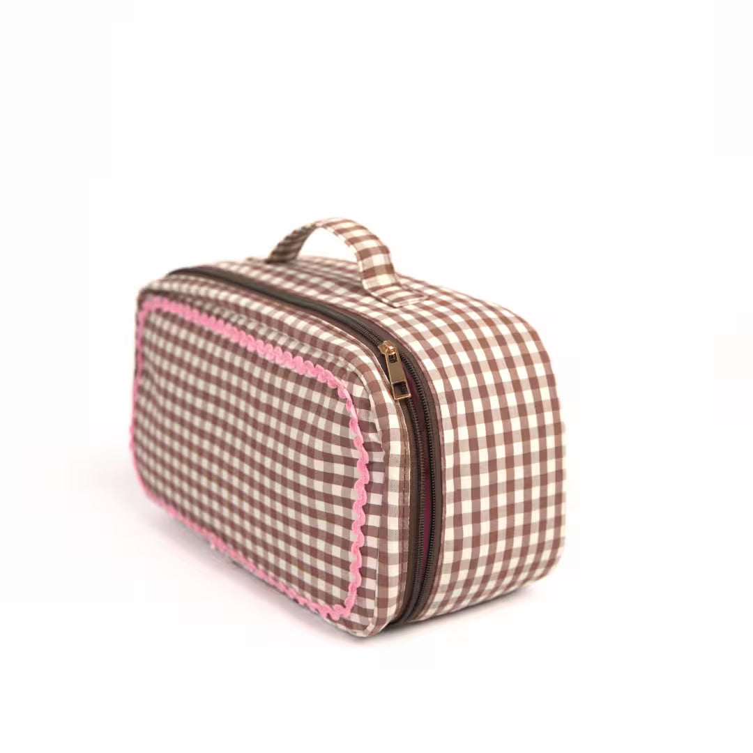 Brown gingham Dyson Airwrap travel pouch with pink detailing and organised compartments