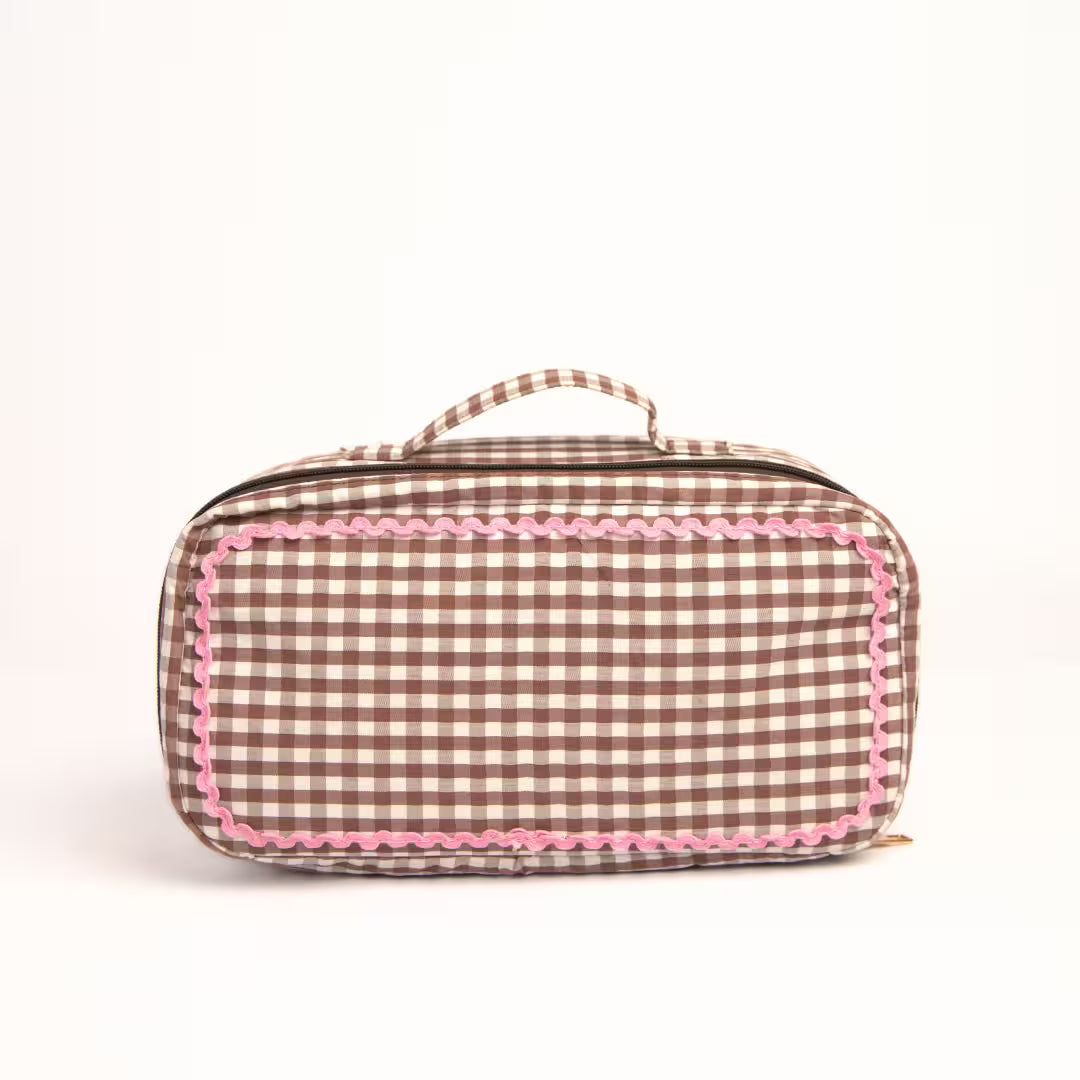 Brown gingham Dyson Airwrap travel pouch with pink detailing and organised compartments